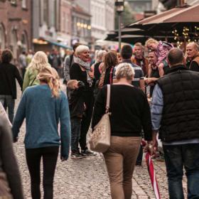 Gågade fyldt med mennesker og byliv.